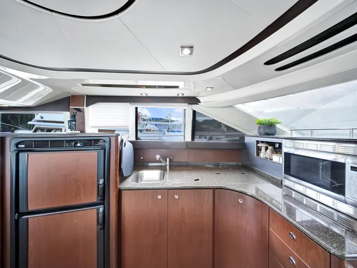 Serenity Yacht Photos Pics Luxurious kitchen interior of 2012 Meridian 441 Sedan yacht with modern appliances.
