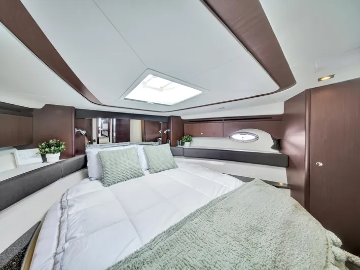 Serenity Yacht Photos Pics Luxurious bedroom interior of 2012 Meridian 441 Sedan yacht with skylight and modern decor.