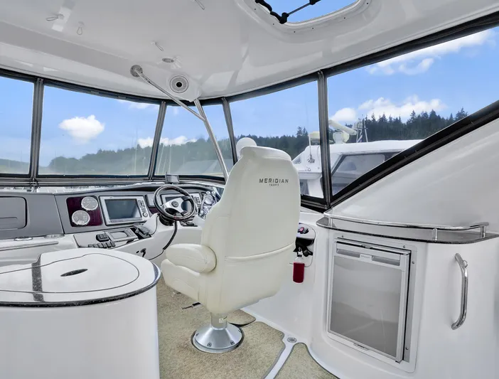Serenity Yacht Photos Pics Interior of 2012 Meridian 441 Sedan yacht with modern helm and panoramic windows.