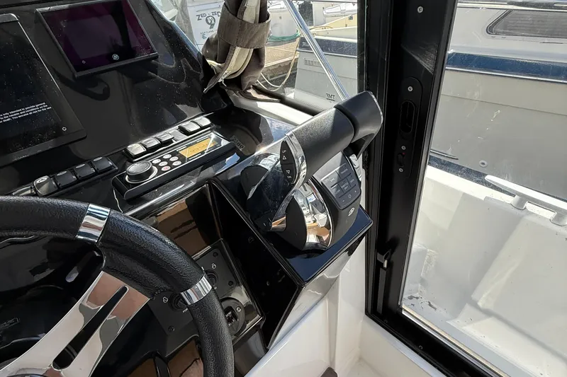  Yacht Photos Pics Interior helm of 2021 Beneteau Antares 9, featuring modern controls and steering wheel.