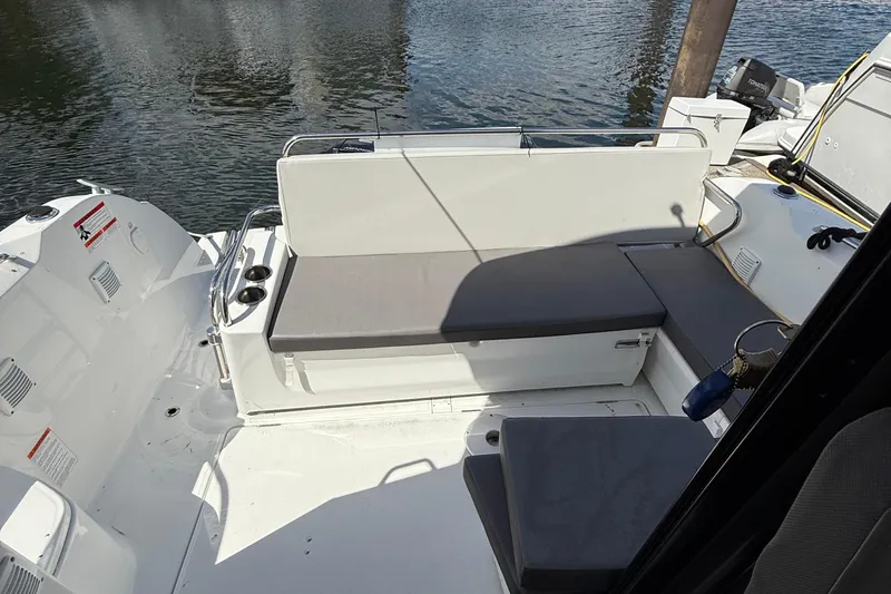  Yacht Photos Pics 2021 Beneteau Antares 9 boat interior with cushioned seating and water view.