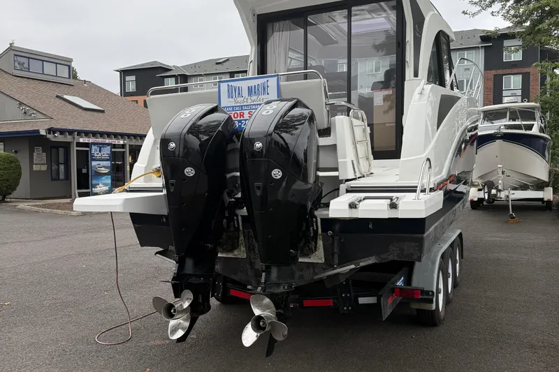 Yacht Photos Pics 2021 Beneteau Antares 9 boat with dual outboard motors on a trailer.