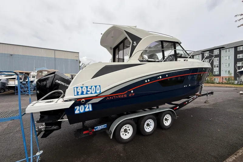  Yacht Photos Pics 2021 Beneteau Antares 9 boat on trailer, displayed outdoors with price tag.