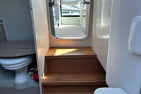 Interior of 2022 Saxdor 320 GTC boat, featuring wooden steps and a compact bathroom.