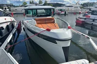 2022 Saxdor 320 GTC boat docked at a marina, featuring sleek design and modern amenities.