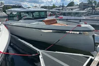 2022 Saxdor 320 GTC boat docked at marina under a partly cloudy sky.