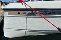 2022 Saxdor 320 GTC boat docked with red rope, sunny day.