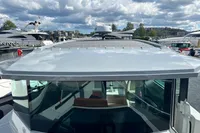 2022 Saxdor 320 GTC boat with sleek design, docked under a cloudy sky.