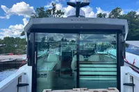 2022 Saxdor 320 GTC boat with glass doors, docked under a blue sky.