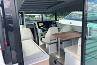 Interior of 2022 Saxdor 320 GTC boat, featuring seating and a wooden table.