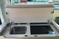 Modern kitchen area on 2022 Saxdor 320 GTC boat with sink and stove.