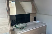Interior of 2022 Saxdor 320 GTC featuring modern sink and mirrored cabinets.