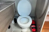 Toilet and fire extinguisher in 2022 Saxdor 320 GTC boat bathroom.
