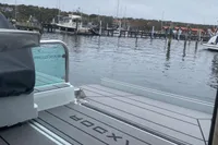 2022 Saxdor 320 GTC boat docked at a marina with calm waters.