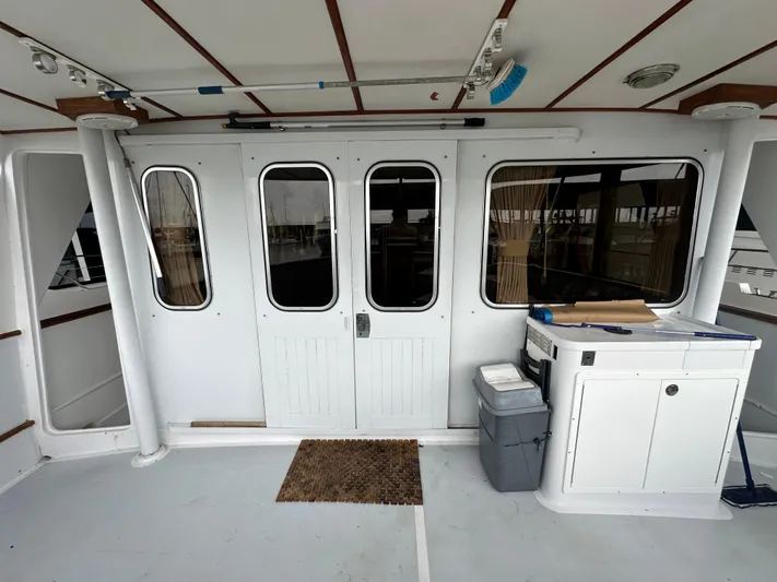 Ranger Yacht Photos Pics 1986 Cheoy Lee 66 Long Range Motor Yacht deck with sliding doors and storage unit.