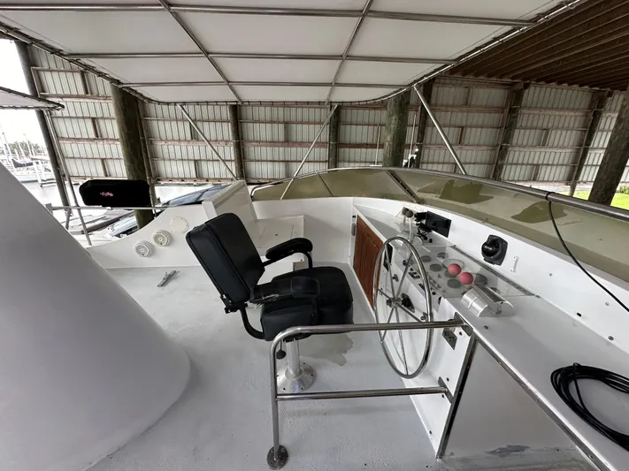 Ranger Yacht Photos Pics 1986 Cheoy Lee 66 Long Range Motor Yacht helm with black captain's chair and controls.
