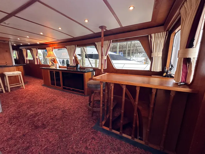 Ranger Yacht Photos Pics Interior of 1986 Cheoy Lee 66 Long Range Motor Yacht with wood paneling and red carpet.
