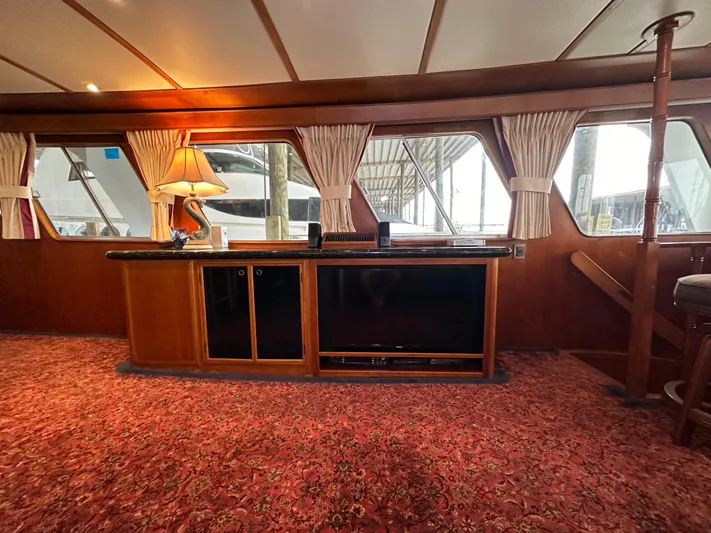 Ranger Yacht Photos Pics Interior of 1986 Cheoy Lee 66 Yacht with wood paneling and red carpet.