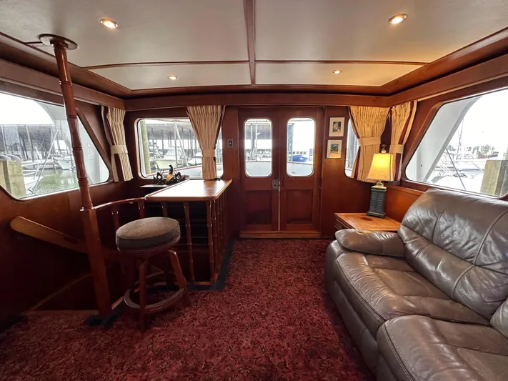 Ranger Yacht Photos Pics Interior of 1986 Cheoy Lee 66 Yacht, featuring cozy seating and elegant wood finishes.