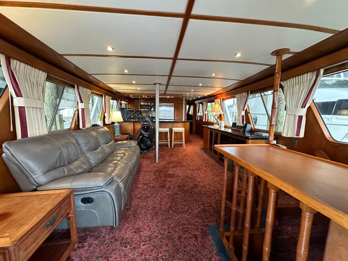 Ranger Yacht Photos Pics Luxurious interior of 1986 Cheoy Lee 66 Long Range Motor Yacht with plush seating and wood accents.