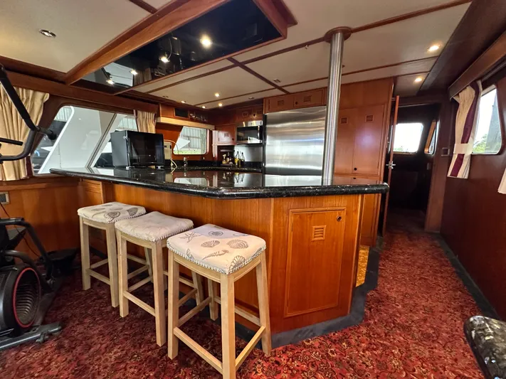 Ranger Yacht Photos Pics Luxurious 1986 Cheoy Lee 66 yacht interior with elegant kitchen and bar seating.