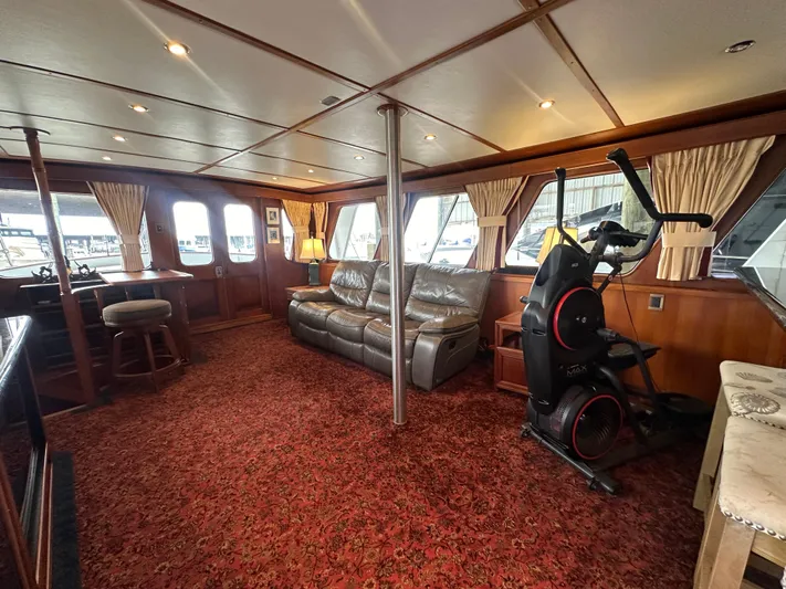 Ranger Yacht Photos Pics Luxurious 1986 Cheoy Lee 66 yacht interior with plush seating and exercise equipment.