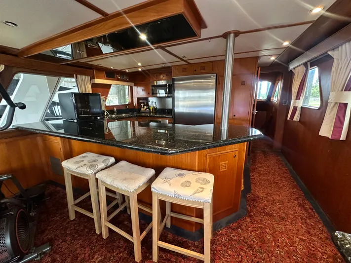Ranger Yacht Photos Pics Luxurious 1986 Cheoy Lee 66 yacht interior with modern kitchen and bar stools.
