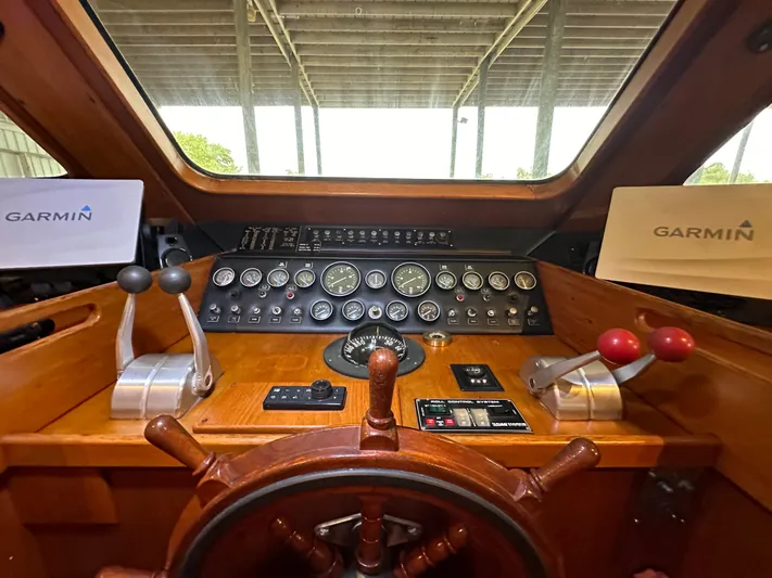 Ranger Yacht Photos Pics 1986 Cheoy Lee 66 Yacht helm with Garmin navigation, wooden wheel, and control panels.