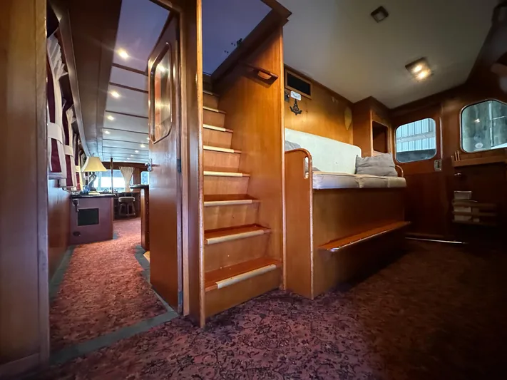 Ranger Yacht Photos Pics Interior of 1986 Cheoy Lee 66 Long Range Motor Yacht with wooden stairs and cozy seating.