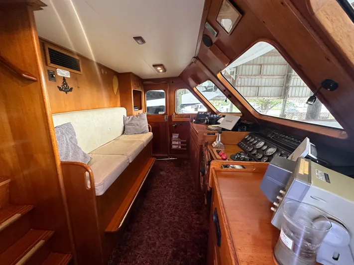 Ranger Yacht Photos Pics Interior of 1986 Cheoy Lee 66 Long Range Motor Yacht with wood paneling and navigation equipment.