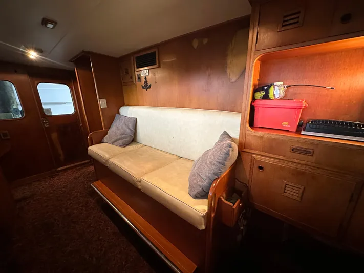 Ranger Yacht Photos Pics Interior of 1986 Cheoy Lee 66 Yacht with sofa and wooden cabinetry.