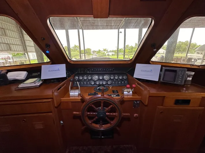 Ranger Yacht Photos Pics Cockpit of 1986 Cheoy Lee 66 Long Range Motor Yacht with wooden steering wheel and navigation instruments.