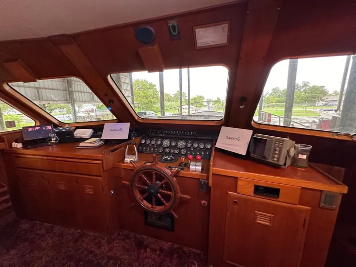Ranger Yacht Photos Pics 1986 Cheoy Lee 66 Long Range Motor Yacht helm with classic wooden dashboard and steering wheel.