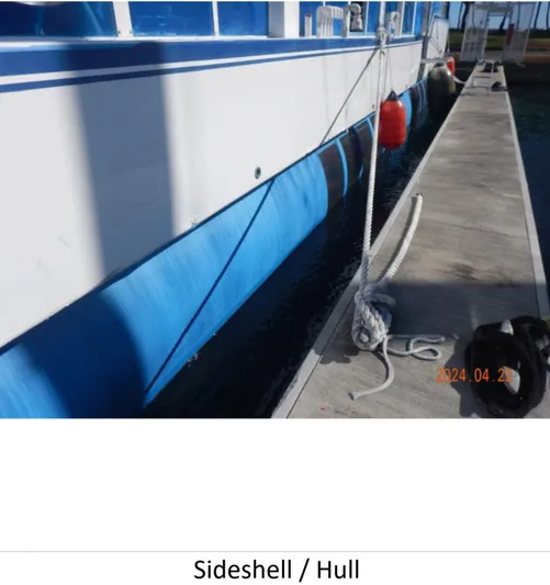  Yacht Photos Pics Custom 2010 Semi Sub Power Catamaran docked, showing sideshell and hull with fenders.