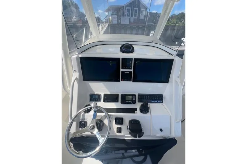 Tesoro Mio Yacht Photos Pics 2017 Regulator 31 boat dashboard with steering wheel and electronic displays.