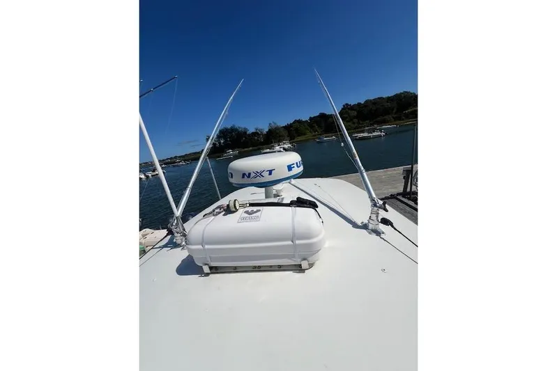Tesoro Mio Yacht Photos Pics 2017 Regulator 31 boat with radar and antennas docked by the water.