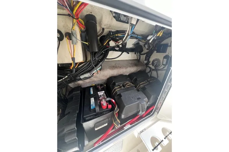 Tesoro Mio Yacht Photos Pics 2017 Regulator 31 boat battery compartment with wiring and electrical components.