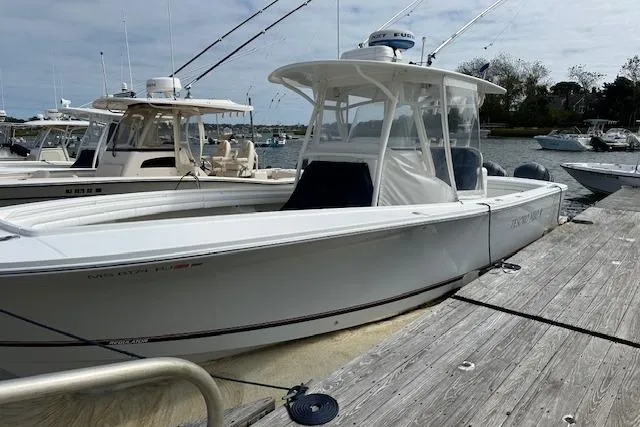 Tesoro Mio Yacht Photos Pics 2017 Regulator 31 boat docked, featuring sleek design and fishing rods.