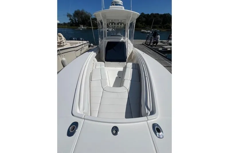 Tesoro Mio Yacht Photos Pics 2017 Regulator 31 boat with sleek white deck and seating, docked by the water.