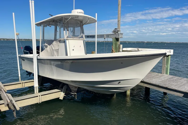  Yacht Photos Pics 2023 Pair Customs 24 Center Console DV boat docked on a sunny day.