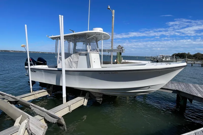  Yacht Photos Pics 2023 Pair Customs 24 Center Console DV boat docked on a sunny day.