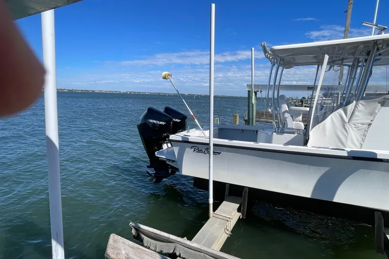  Yacht Photos Pics 2023 Pair Customs 24 Center Console DV boat docked on a sunny day.