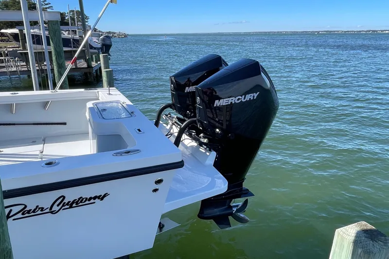  Yacht Photos Pics 2023 Pair Customs 24 Center Console DV boat with dual Mercury engines docked by the water.