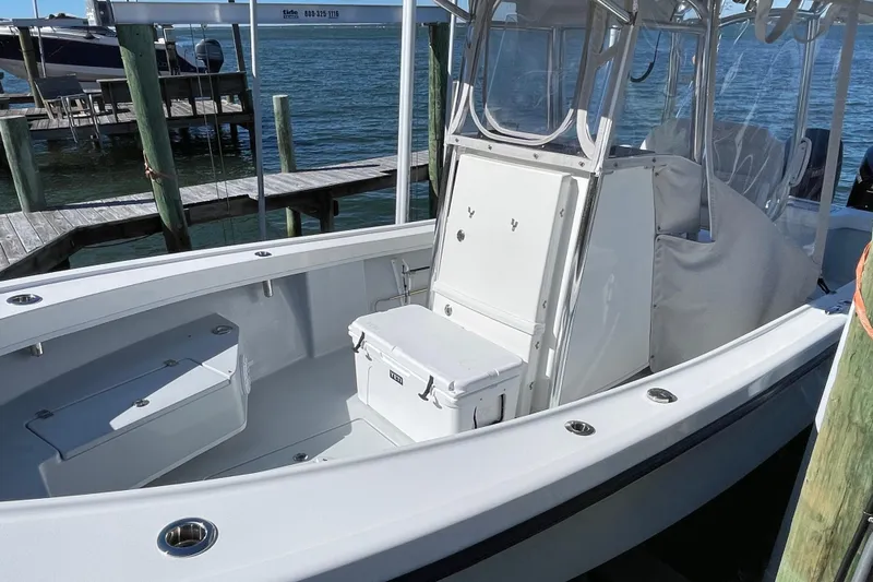 Yacht Photos Pics 2023 Pair Customs 24 Center Console DV boat docked by the water.