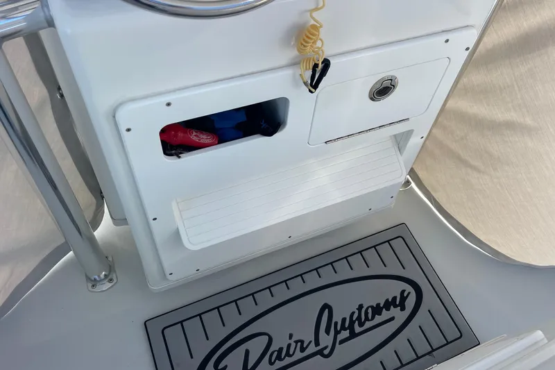  Yacht Photos Pics 2023 Pair Customs 24 Center Console DV boat interior with storage compartments and branded mat.
