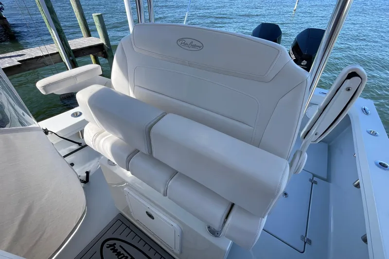  Yacht Photos Pics 2023 Pair Customs 24 Center Console DV boat with white seating, docked by the water.