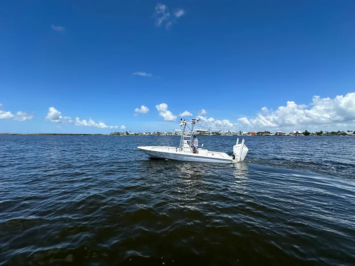  Yacht Photos Pics 2024 Lake & Bay 25 Open boat cruising on a sunny day.