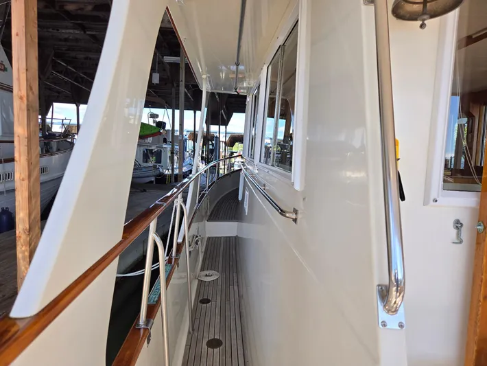 Carina Yacht Photos Pics Side deck view of a 1990 Grand Banks 36 Europa yacht in a marina.