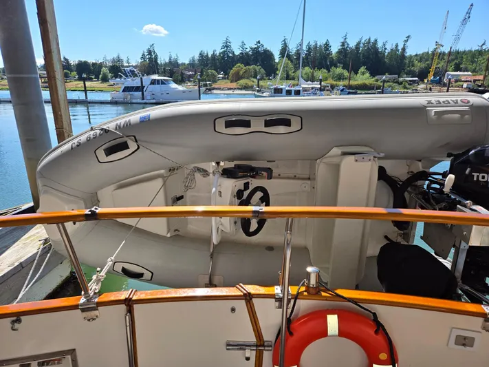 Carina Yacht Photos Pics Inflatable boat on Grand Banks 36 Europa, 1990, docked with scenic marina background.