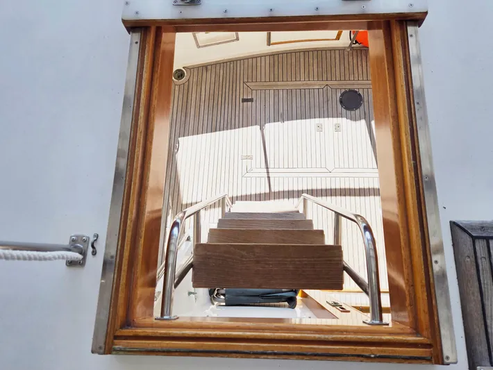 Carina Yacht Photos Pics Staircase view inside 1990 Grand Banks 36 Europa yacht, featuring wooden and metal details.